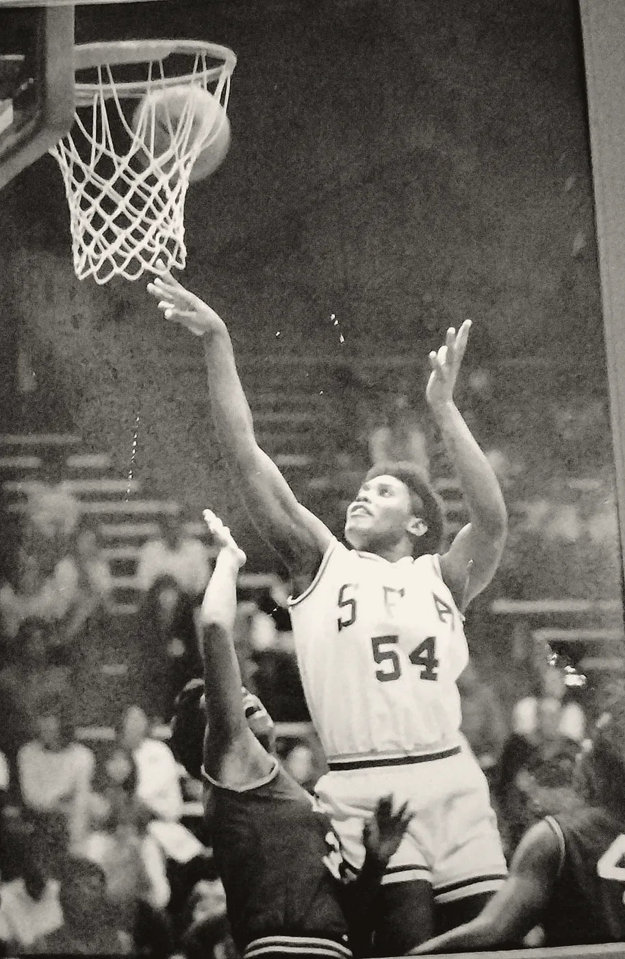Annie Norris, number 54, reaching up to lay the ball in over a defender