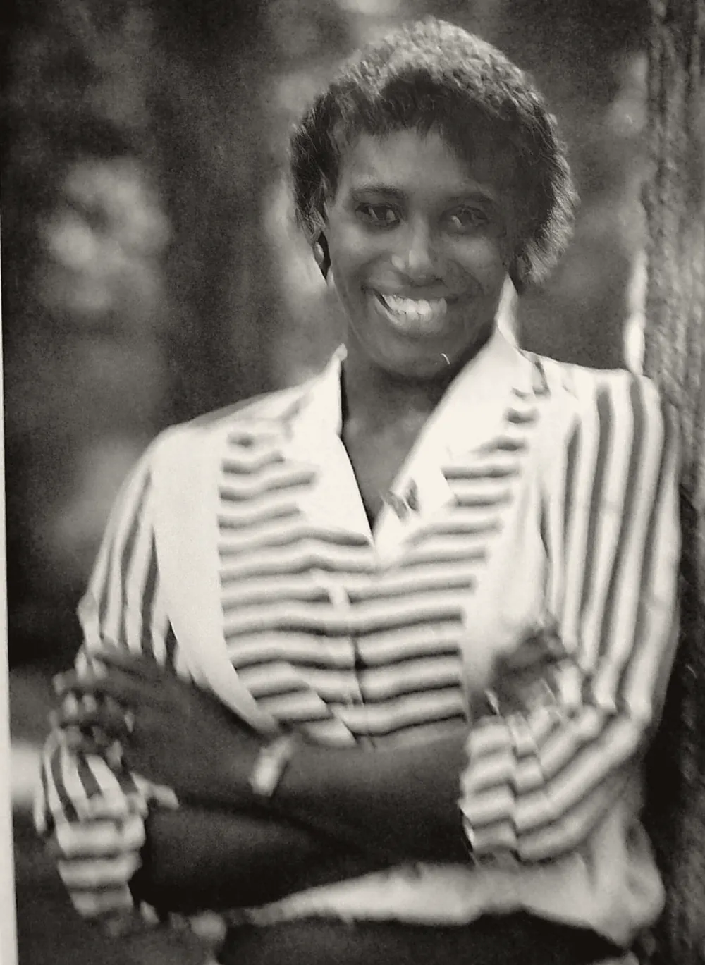 Black-and-white portrait of Antoinette &ldquo;Annie&rdquo; Norris smiling, arms crossed, in a striped blouse