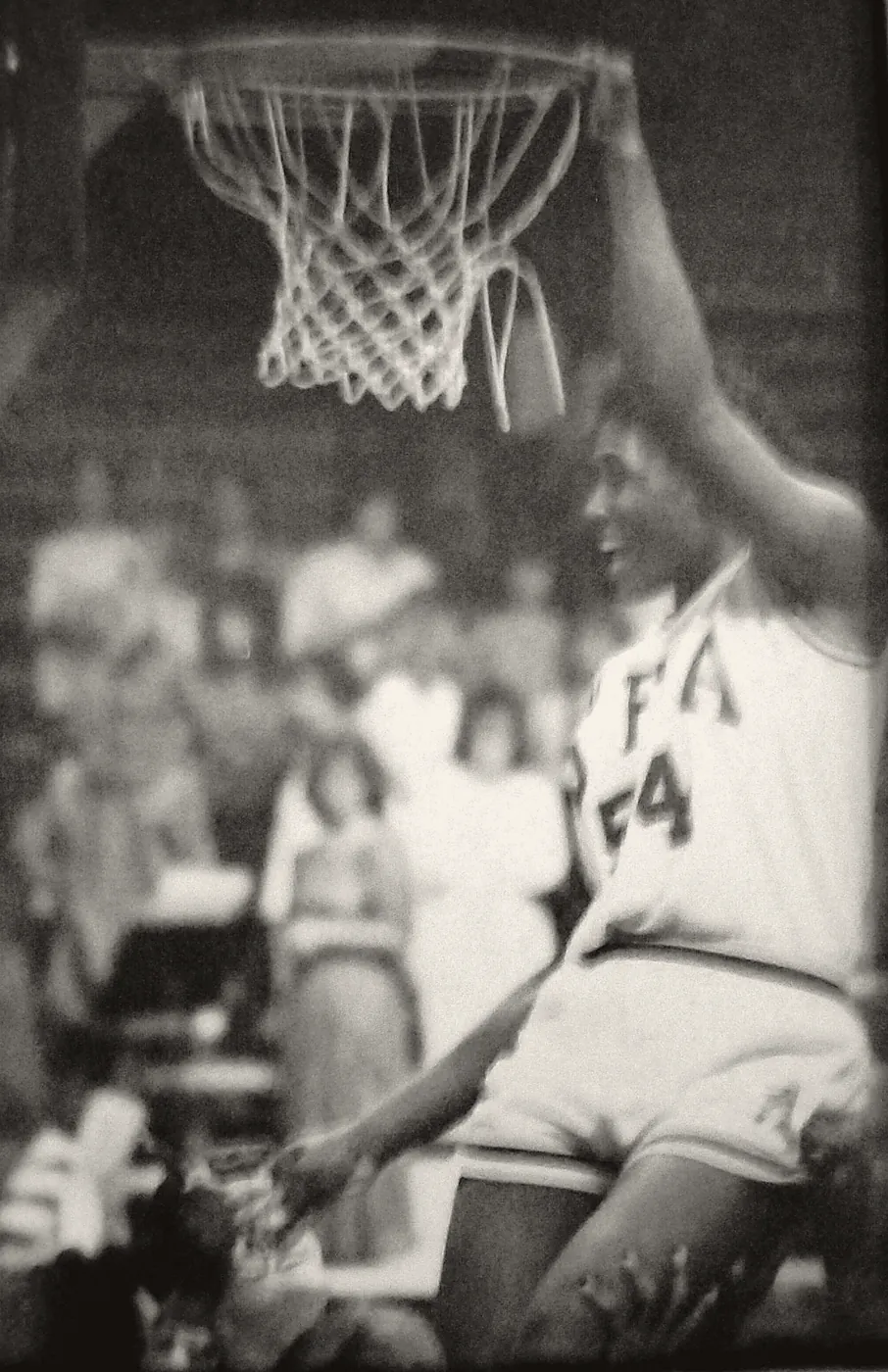 Annie Norris, number 54 for the Stephen F. Austin Ladyjacks, hanging from the rim after a dunk attempt