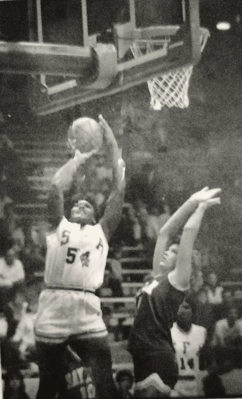 Annie Norris, number 54, going up under the basket against a defender